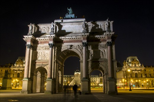 People walk from the Champs Elysees towards the Louvre.