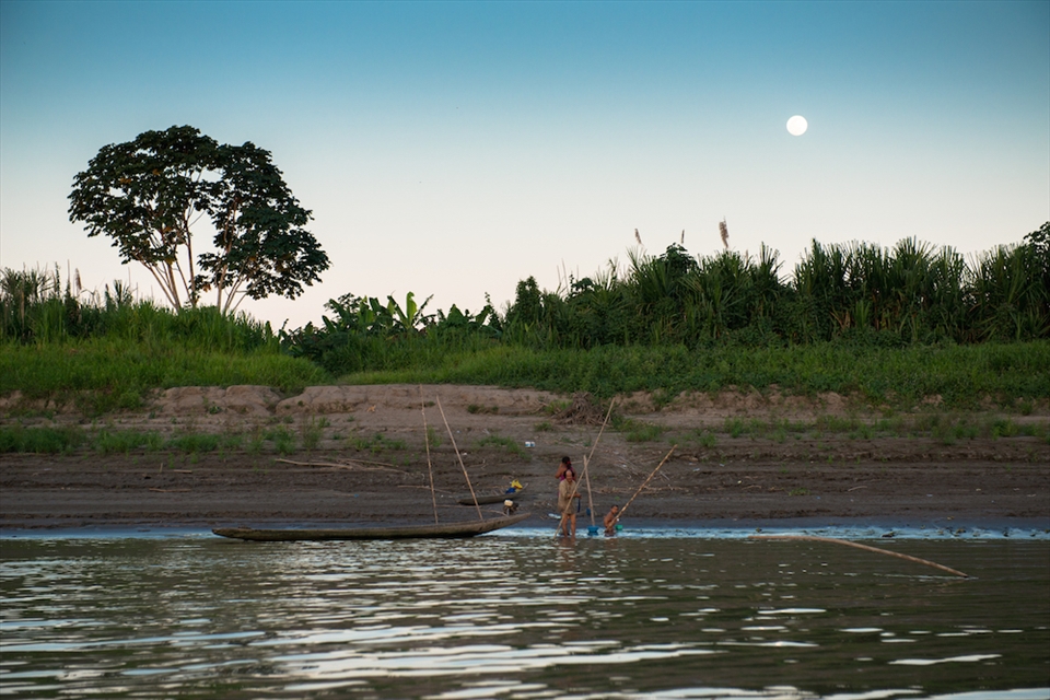 A family of Shipibo-Conibo indians washes up as the moon rises