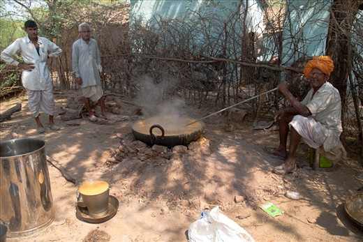 This was the first time that I saw men cooking sauces over an open fire.  The silver stick was a tube and it seemed like he was tasting the sauce through it. 