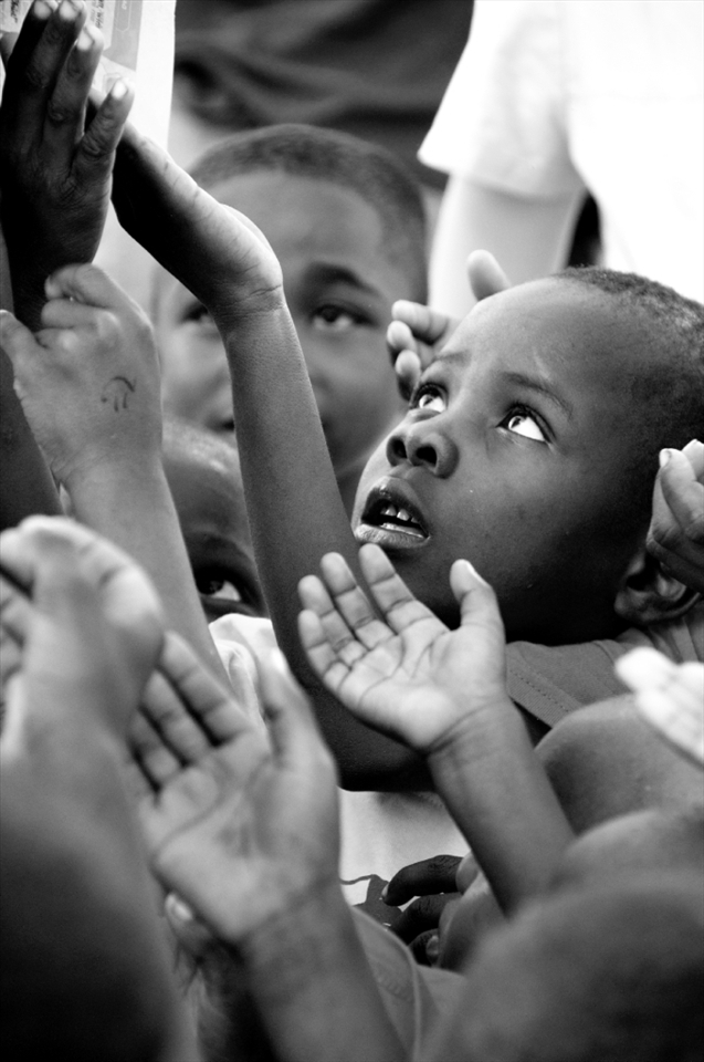 This photograph was taken on one of our off site days. We packed up our clinic and went to a surrounding orphanage where we provided medical attention and passed out goodies and played games with the children. This little boy was almost lost in the sea of children trying to be first in line to collect a treat from one of our Haitian translators. 