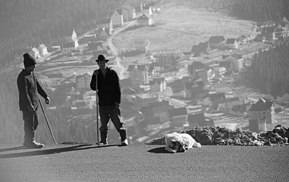 This photo includes the two shepherds ,their trusting dog and a back view of Ranca,a popular oversaturated mountain resort.No matter how much things change,or how much is being build ,tradition remains.