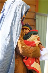 An Afghan woman stands breastfeeding her child while waiting in line to receive aid from the Missionaries of Charity – better known as the Mother Teresa nuns. 

The nuns who have lived in Kabul since 2004 help almost 300 Afghan families they have personally visited and found to be in dire need. Afghanistan has no welfare system to support the poor, nor does it have any public acceptance of Christianity in the form of physical churches or similar. The nuns supply the families on a weekly basis with basic food, clothing, and other material needs through funding they receive from the Motherhouse in India.
: by cathjam, Views[2382]