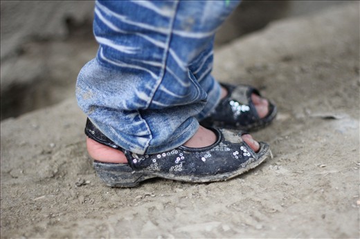 A young girl wears jeans and fancy shoes in a street in Kabul. Jeans were practically banned by the Taliban regime because of their Western origin while girls were not allowed outside the home. Now, just over a decade later, a girl is publicly wearing jeans in the street with sparkles on her shoes. 