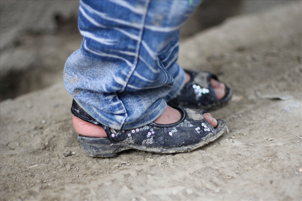 A young girl wears jeans and fancy shoes in a street in Kabul. Jeans were practically banned by the Taliban regime because of their Western origin while girls were not allowed outside the home. Now, just over a decade later, a girl is publicly wearing jeans in the street with sparkles on her shoes. 