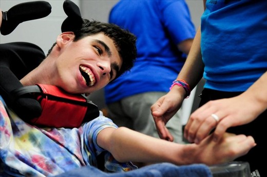 Even disability does not stop this young man from using his facial muscles to laugh and smile.