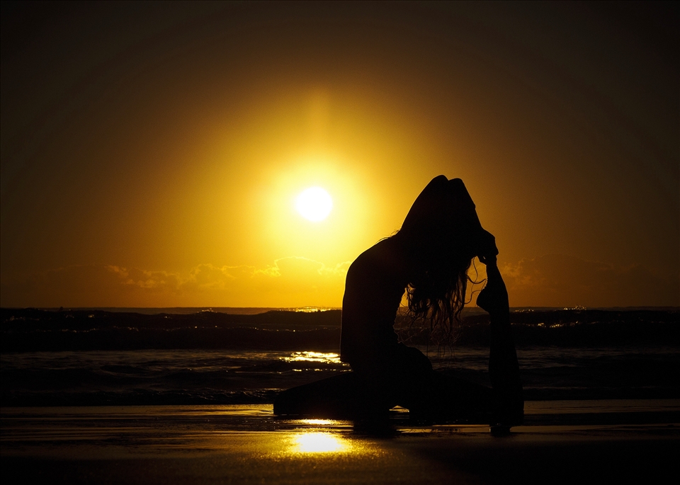 A new days begins, sunrise yoga on one of Sydney's beaches