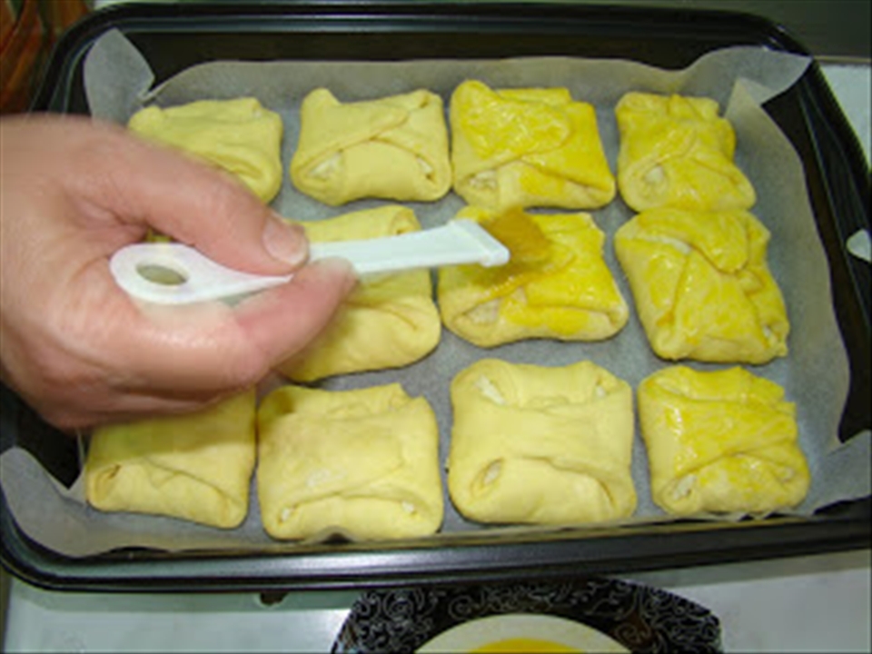 folded pastries and egg-washing