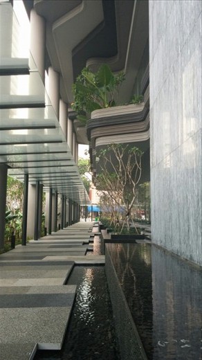 The sidewalk in front of the hotel. 