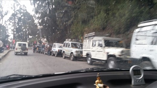 Line of jeeps through center of town
