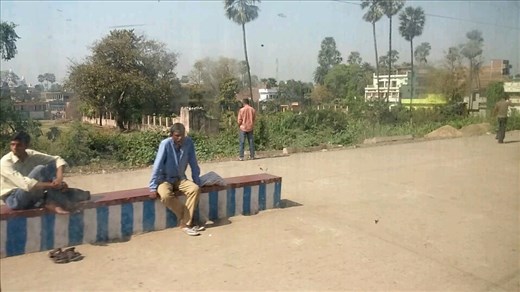 Pretty sure the guy in the background is taking a leak. There's a second guy 50 feet away doing the same thing.