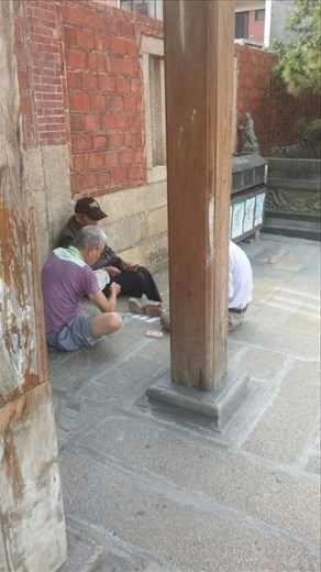 Old men playing cards in the middle of the day. Old people in Taiwan can be found doing this in the oddest places.