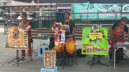 Native people in full costume performing their music for tourists at the ferry ports on the lake. 