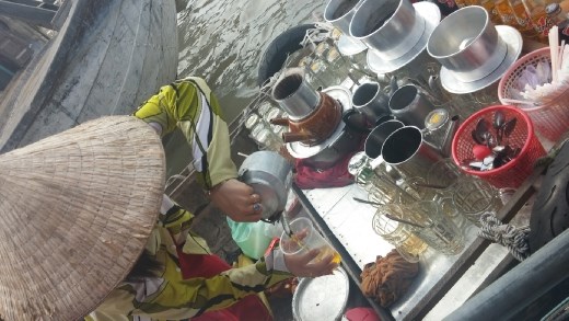 In addition to fruit and veg, you can get a coffee at the floating market