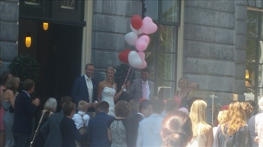 Bride and Groom emerging from church to a crowd of guests