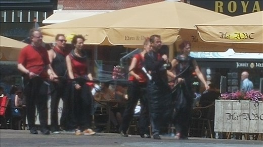 Some sort of protest group - chained together and dressed oddly