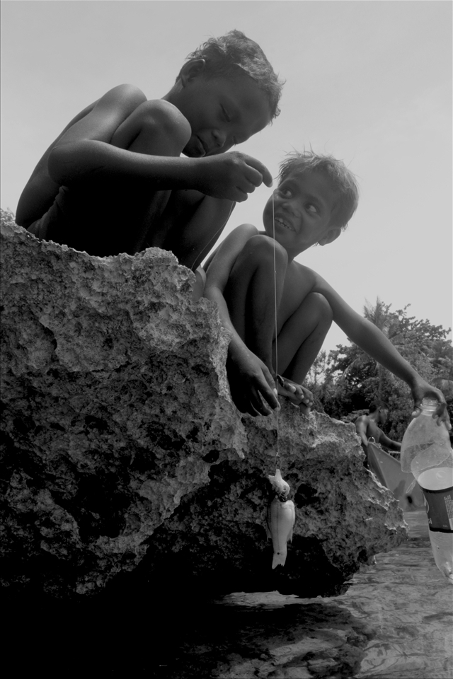 Ati kids catching fish. Fishing is the Atis' main source of living. According to them, their seas were filled with plenty of fishes before tourists started flocking to their island.