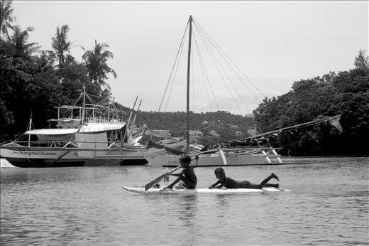 Ati kids having fun in the sea. The hotels and resorts in the background may soon take what little is left of the Atis' ancestral domain.