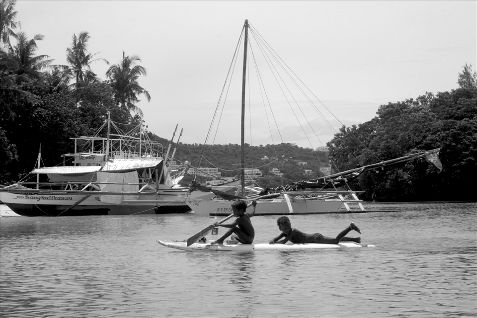 Ati kids having fun in the sea. The hotels and resorts in the background may soon take what little is left of the Atis' ancestral domain.