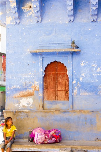 This little girl was probably already working to earn her living, no doubt supporting her parents. 
The sack full of  used bottles and boxes was her mother's and while the girl waited for her to come back, I was lucky to capture her taking a break watching the world around her.