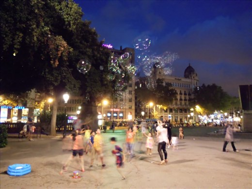 Childhood innocence: The magic of bubbles at dusk.
