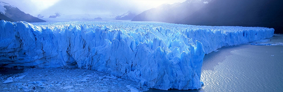 Sunlight warms the glacier, it fractures, sending a thundering rumble below. 