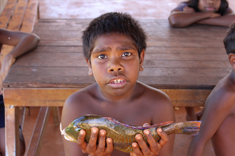 I love taking pictures of people   and capturing emotions. For me this picture resembles a level of innocence and confusion after we gave this kid one of our catches. Cameras weren't something these kids were used to.