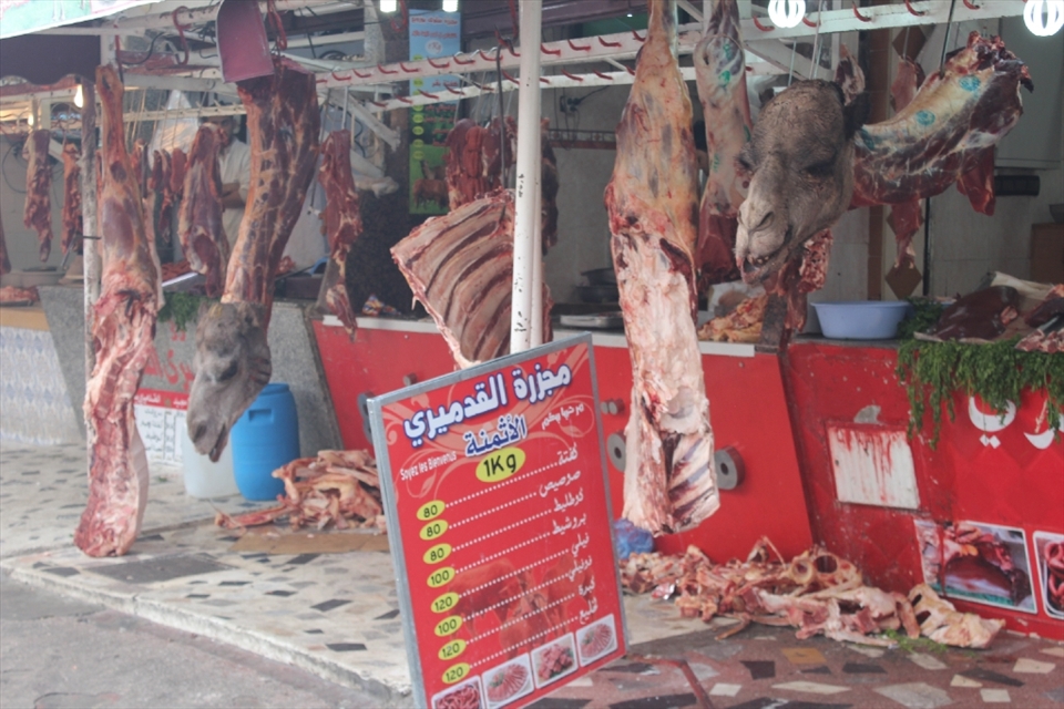 The Butcher with Camel hanged in his meat hanger, with a big list of prices next to it, a way of buying meat, traditional but effective.