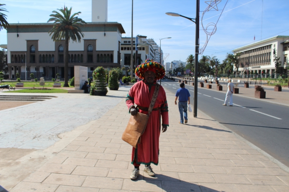 A nature juice seller or shall I say a water seller with his old antique style Moroccan Clothes, and his water jog made out of camel leather to keep the water cool