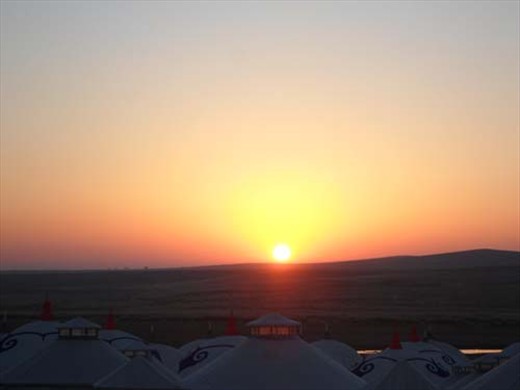 Day 2 (Morning): Sunrise moves ahead the horizon as the crest of the Mongolian yurts, traditional homes, remains. We rose early to watch the beautiful rising of the sun overlooking the grassy plateau. Following breakfast, we hopped in our mobile home tour van to drive over four hours to our next destination on our nomadic quest in Inner Mongolia, North China, the country's third largest province. 