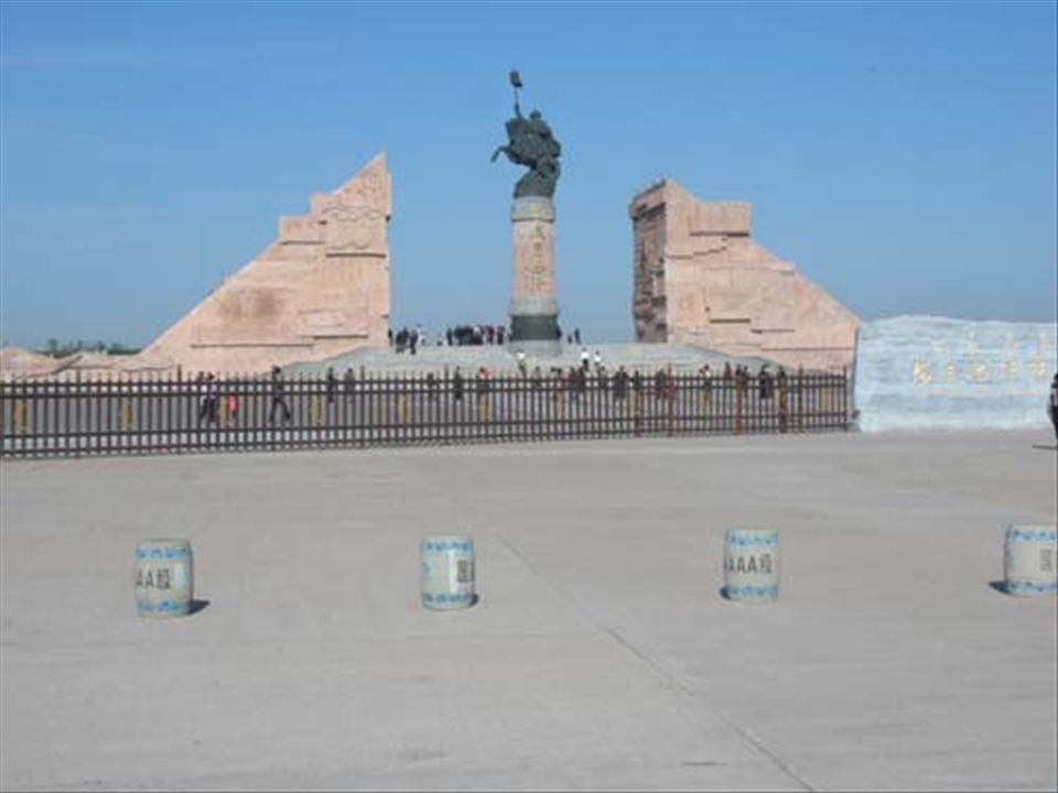 Intrepid History - Day 3: Entranceway to the Genghis Khan Mausoleum; Khan was a mighty man of conquest. The formidable venue housed numerous yurts filled with trinkets and garments of Mongolian history, including a portrait of what Khan may have looked like. A tour of the massive cemetery ends with a perusal of the museum that contains numerous artifacts of the Mongol culture and people.