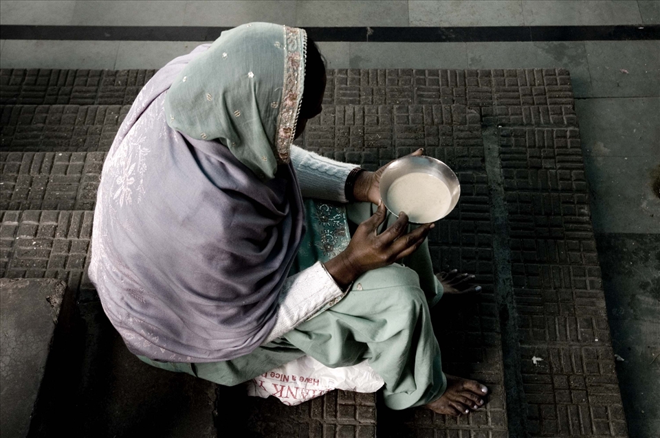 Woman drinking milk at the Golden Temple in Amritsar, India