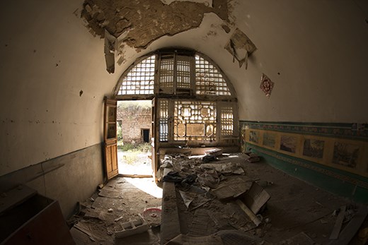 Wubao is an abandoned town overlooking part of the yellow river, where now only one couple remains. This room is one of many that had been left to deteriorate, with the paint peeling of the ceiling, and dust smothering the floor, and yet the sunlight streaks through the intricate window in a beautiful way. 