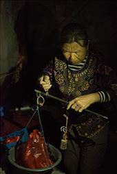 An elderly woman takes time out of closing her fruit stall to weigh apples with an old fashioned form of scales. : by charlottesams, Views[244]