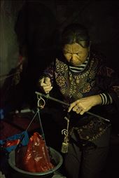 An elderly woman takes time out of closing her fruit stall to weigh apples with an old fashioned form of scales. : by charlottesams, Views[174]