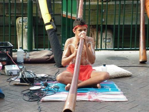 Aboriginal boy at Sydney Wharf 
keeping his ancestral traditions alive with a modern twist. Great didgeridoo player and I was able to recorded some of his performance.