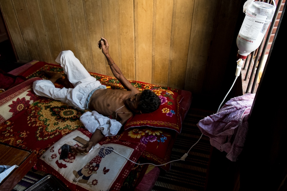 I met him in the the Boeng Kak slum area of Phnom Penh.  A mutual friend suggested I meet this highly respected traditional healer and get a talisman to protect me on the journey back home.  When I walked into his home I was startled by the contrast between my expectations and my reality.  There laying before me cachectic, ill and hooked up to a lipid IV infusion was this revered healer my friend had told me about.  