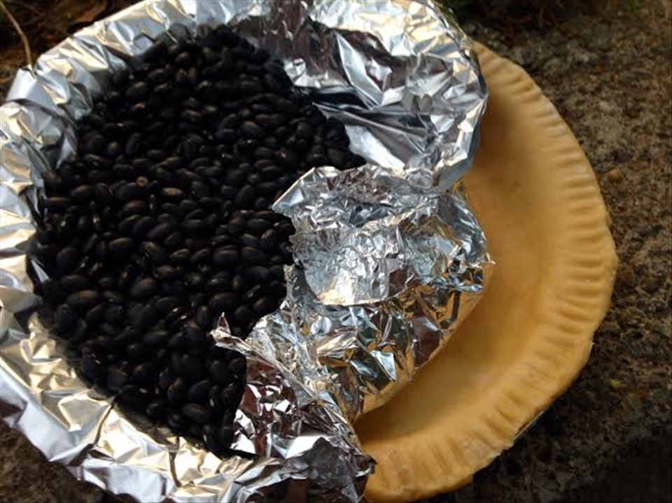 Use dried beans to weigh down the pastry while pre-baking the crust.