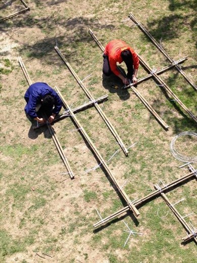 boys assembling piece, seen from bridge above