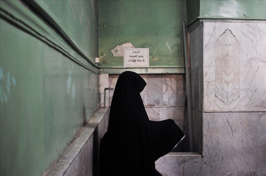 Two women are praying in the corner of a chamber adjacent to the Shrine of Hussein. Umayyad Mosque, Damascus, Syria.