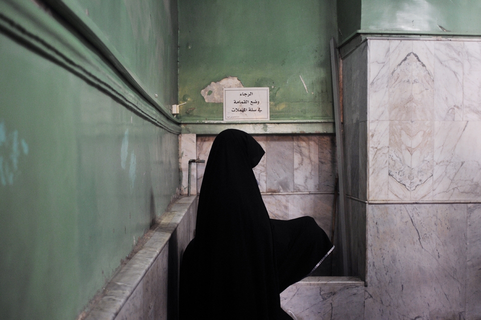 Two women are praying in the corner of a chamber adjacent to the Shrine of Hussein. Umayyad Mosque, Damascus, Syria.