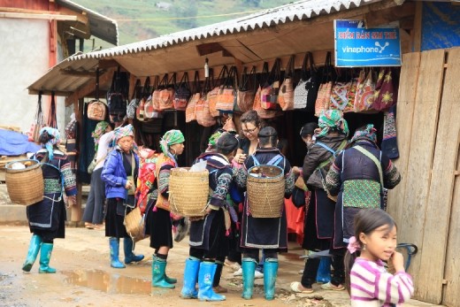 Black Hmong women trying to sell stuff to a tourist