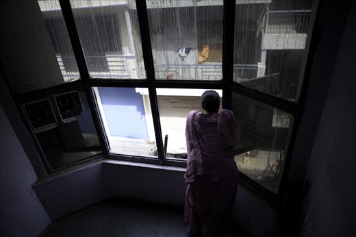 A doctor at an AIDS clinic takes a moment to try to capture a breeze after power to the building cuts out again. The dirty windows and back street location belies the dedication, care and love the staff exhibit to their patients - patients who are all extremely poor, marginalised, and ridiculed. In this clinic the patients are treated like humans, giving them a dignity and a sense of hope they would otherwise never have seen.