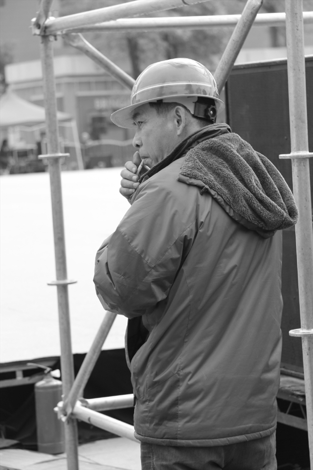Chinese worker taking a rest and smoking