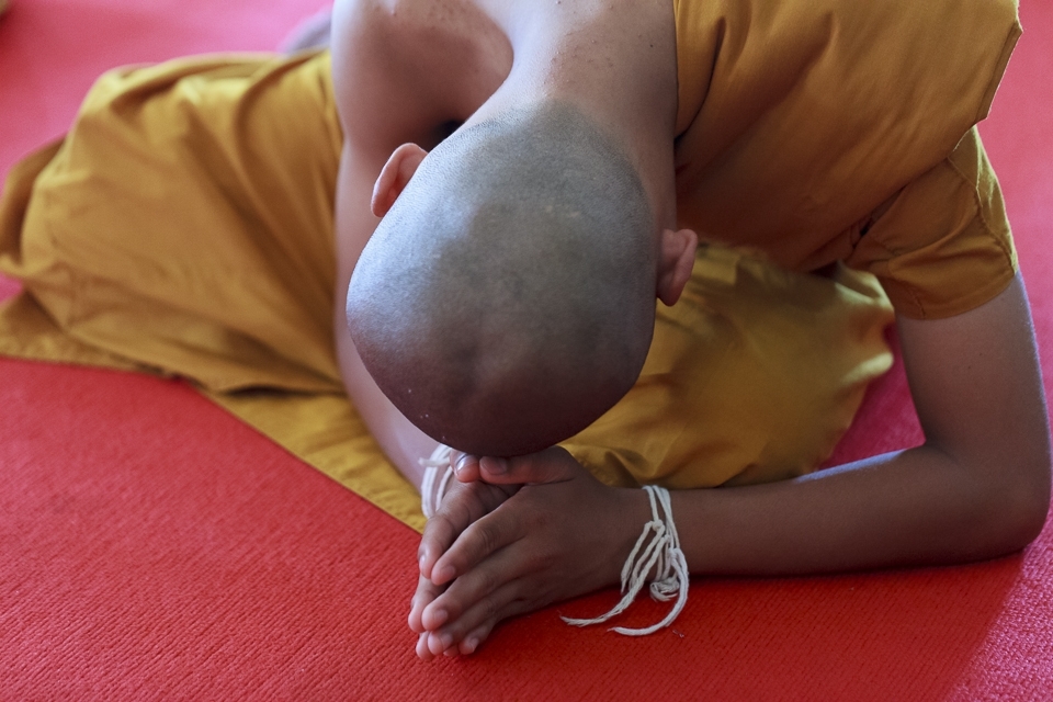 5 ) A new novice bows in prayer, as he leaves the world he knows for a simple, unfamiliar life and a higher calling.
