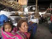 A woman carries her child in the customary fashion as she waits by her produce for a prospective buyer in the market closest to the tourism center of Cusco.: by ciaranballantyne, Views[282]