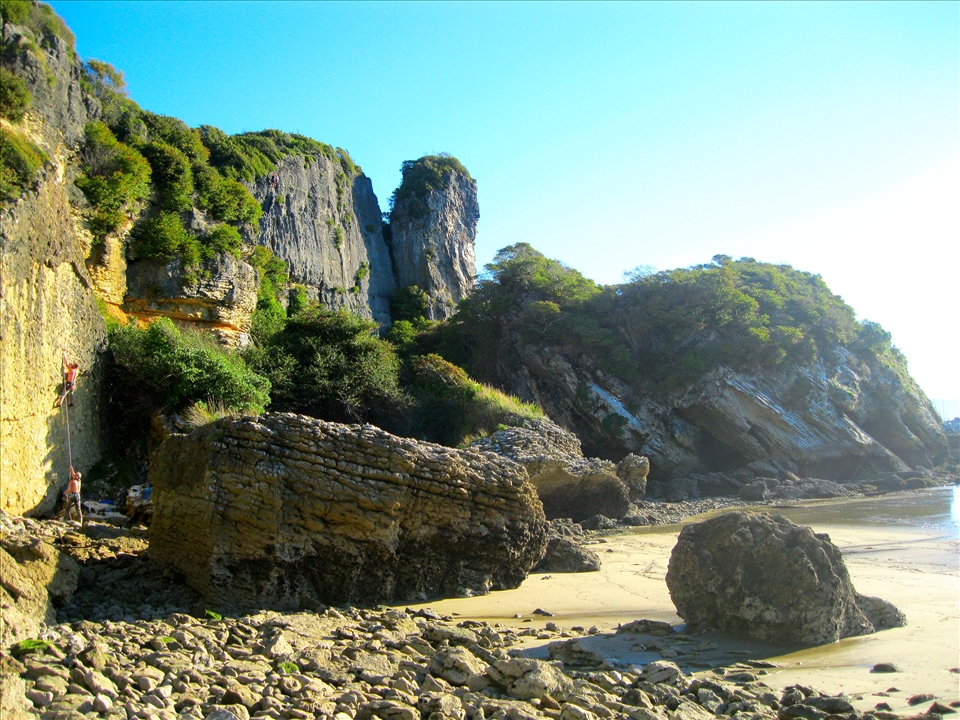 Coastal rock climbing in the South Island on Piha Beach
