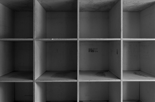 Many of the classrooms had shelves in which students could place their belongings.  They are all empty now, holding on to the name tags and stickers once bestowed upon them by their young users.

