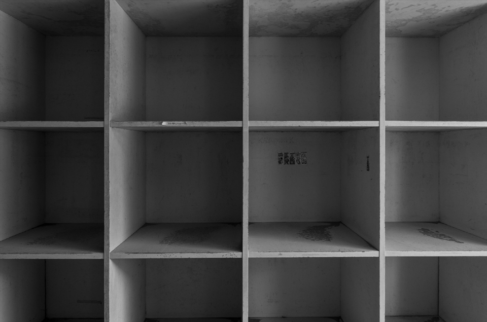 Many of the classrooms had shelves in which students could place their belongings.  They are all empty now, holding on to the name tags and stickers once bestowed upon them by their young users.
