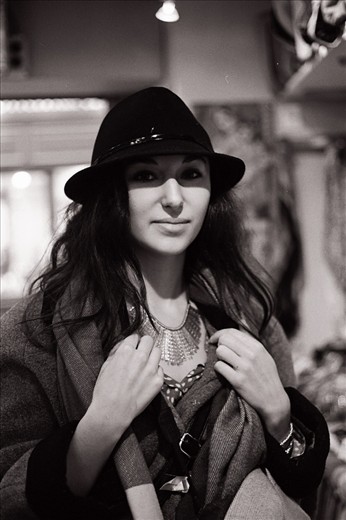 A young woman with an eye for style stops into one of Montmartre's local boutiques to try on a necklace. Afterwards, she celebrates her purchase with a Nutella crêpe and a hot expresso at a café down the street.