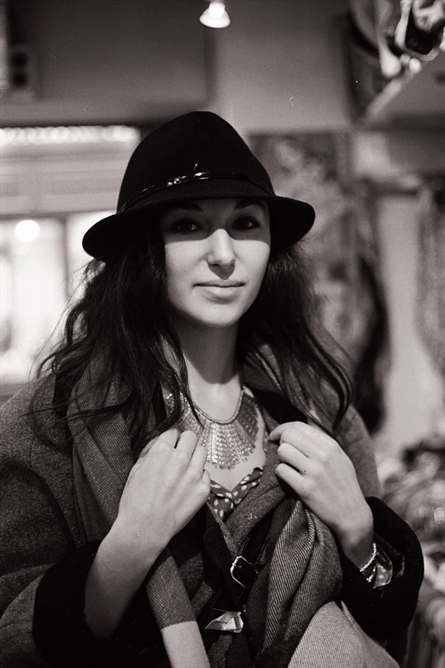 A young woman with an eye for style stops into one of Montmartre's local boutiques to try on a necklace. Afterwards, she celebrates her purchase with a Nutella crêpe and a hot expresso at a café down the street.